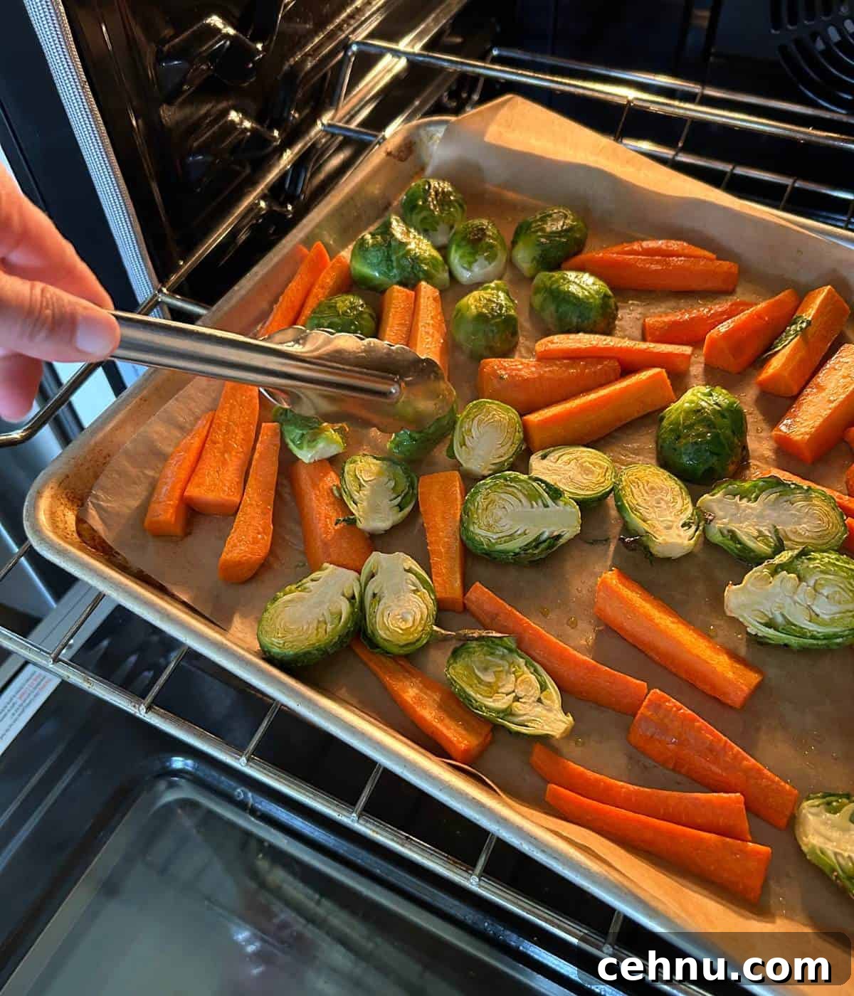 Flipping vegetables half way through oven roasting.
