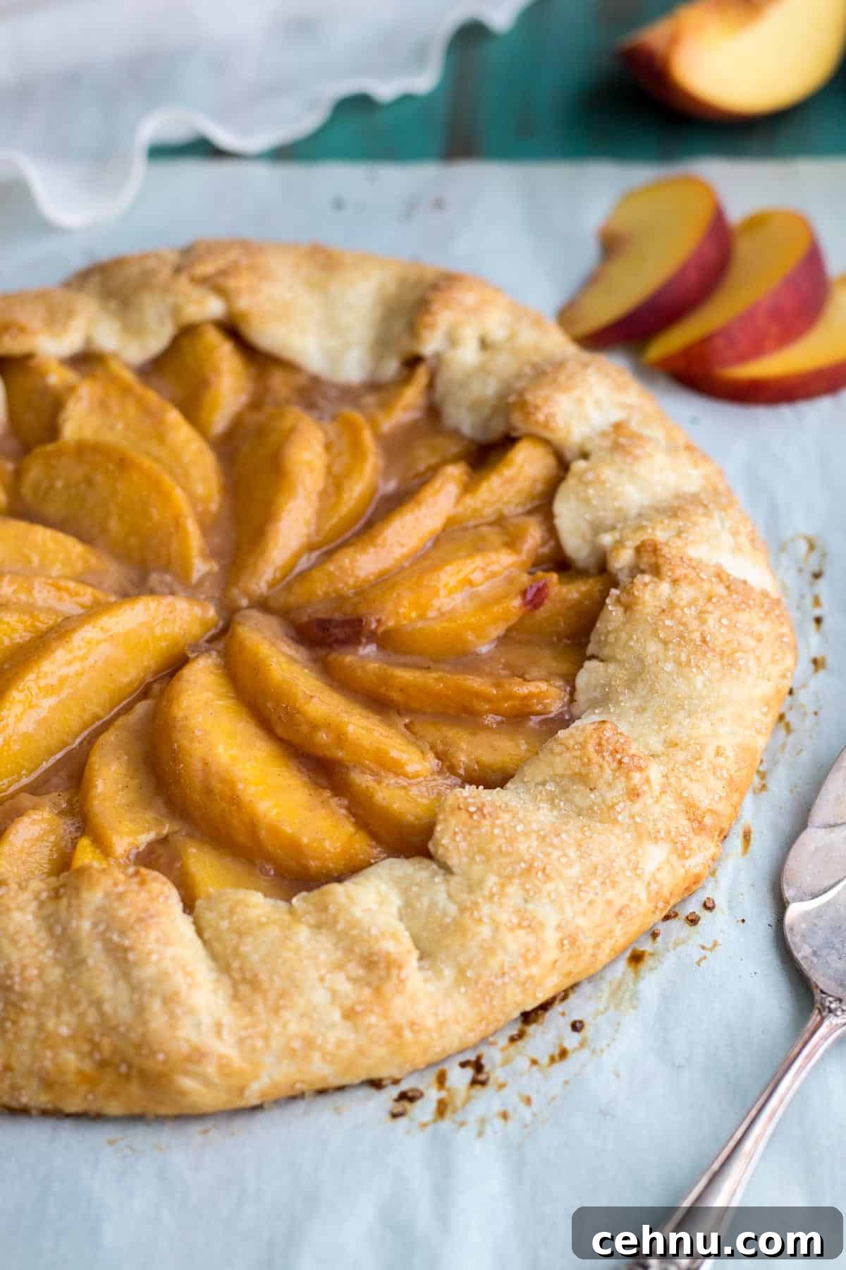 Rustic Peach Crostata or Galette Recipe 7 Golden brown peach crostata on parchment paper.