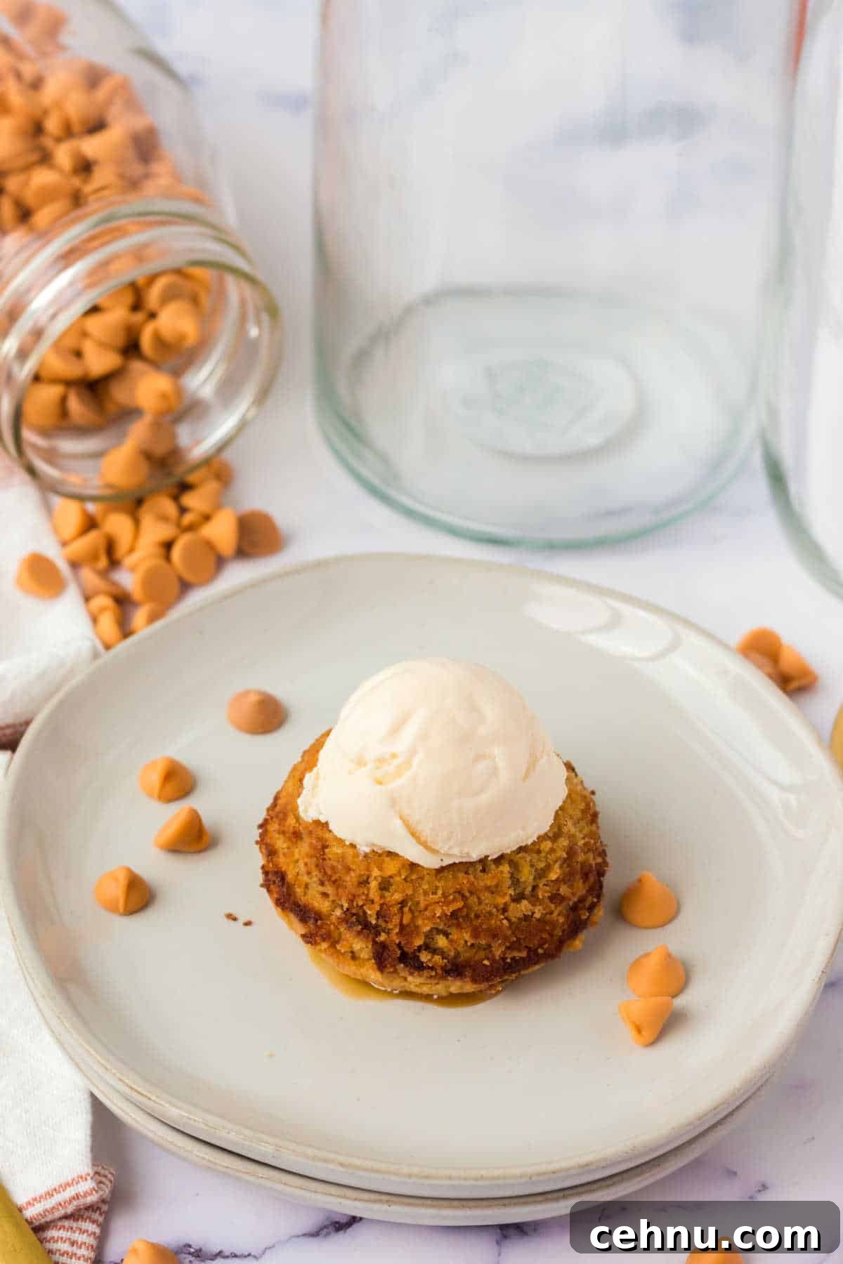 Molten Butterscotch Lava Cakes Recipe 2 A butterscotch lava cake on a plate topped with a scoop of vanilla ice cream.