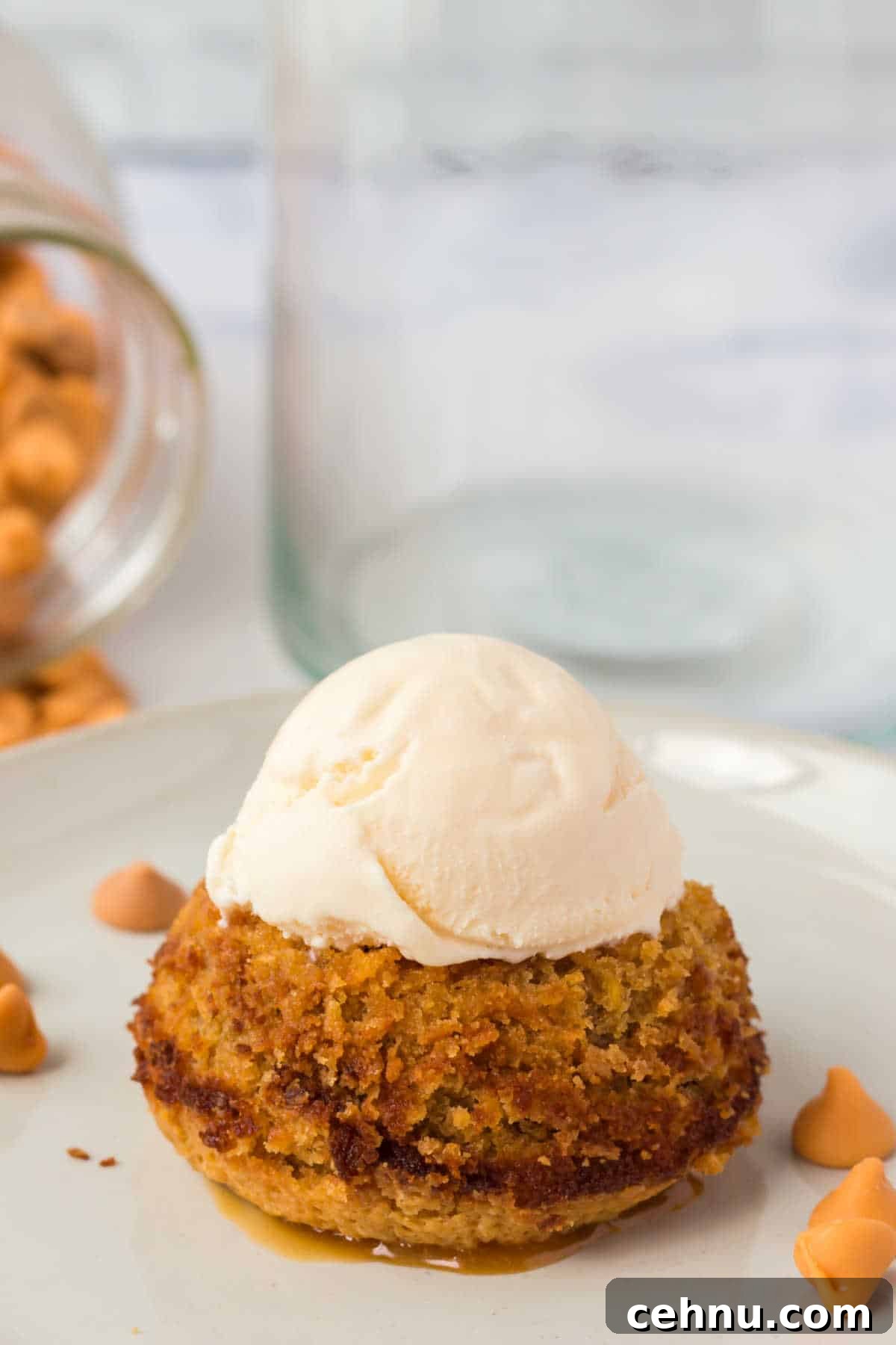 Molten Butterscotch Lava Cakes Recipe 5 The recipe on a plate topped with vanilla ice cream.