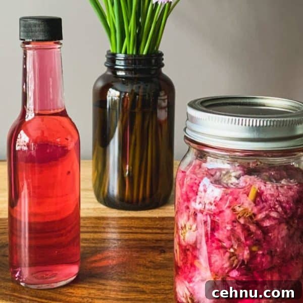 Mason jar and bottle with purple chive vinegar.