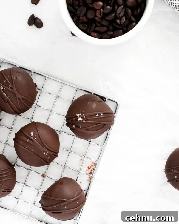 overhead shot of chocolate dipped chocolate truffles on a small wire rack