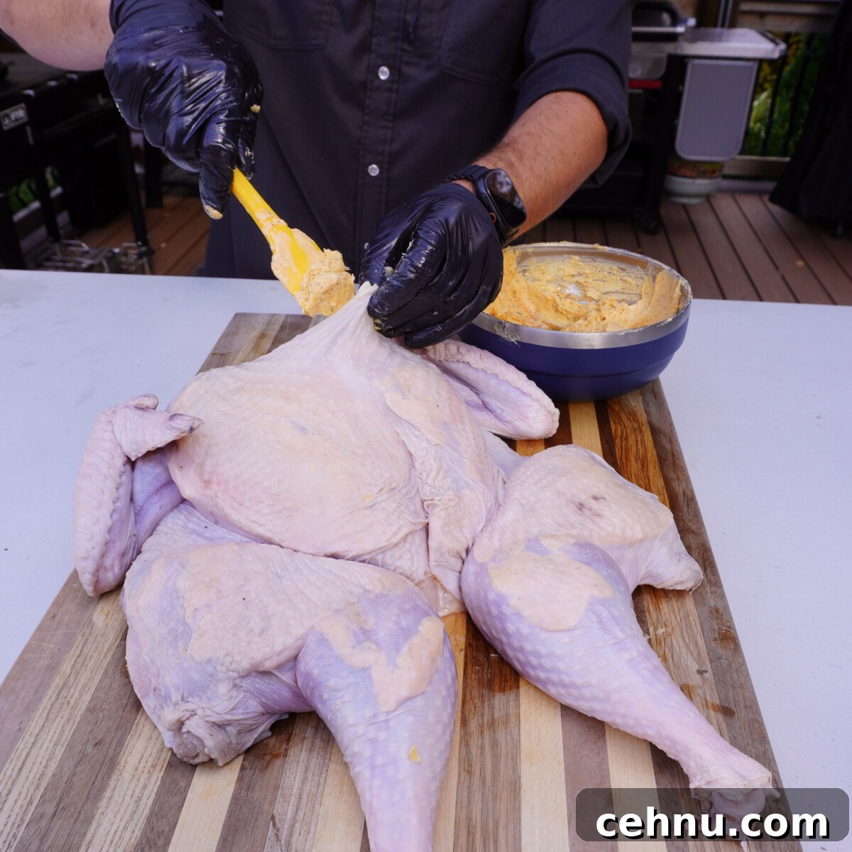 adding layers of butter under the turkey skin.