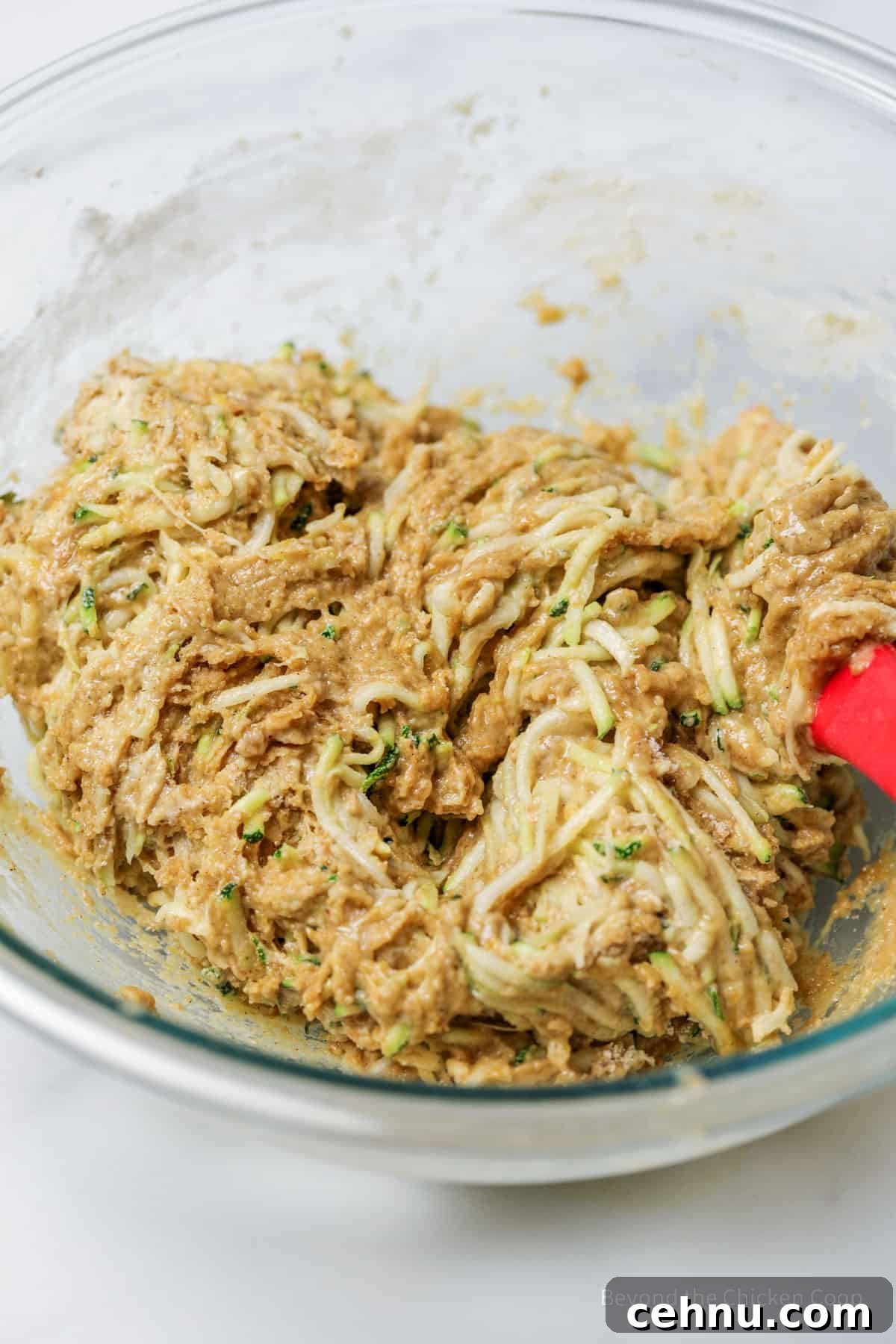 Zucchini bread batter in a large glass bowl.