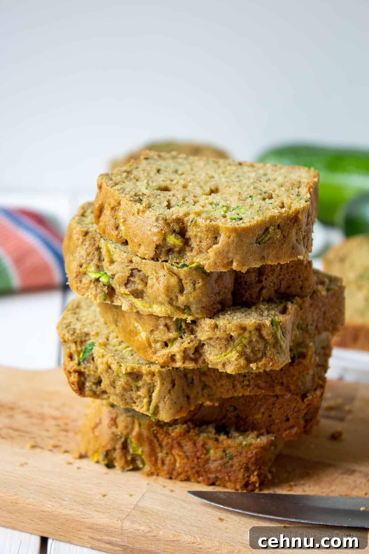 Slices of zucchini bread stacked on a board.