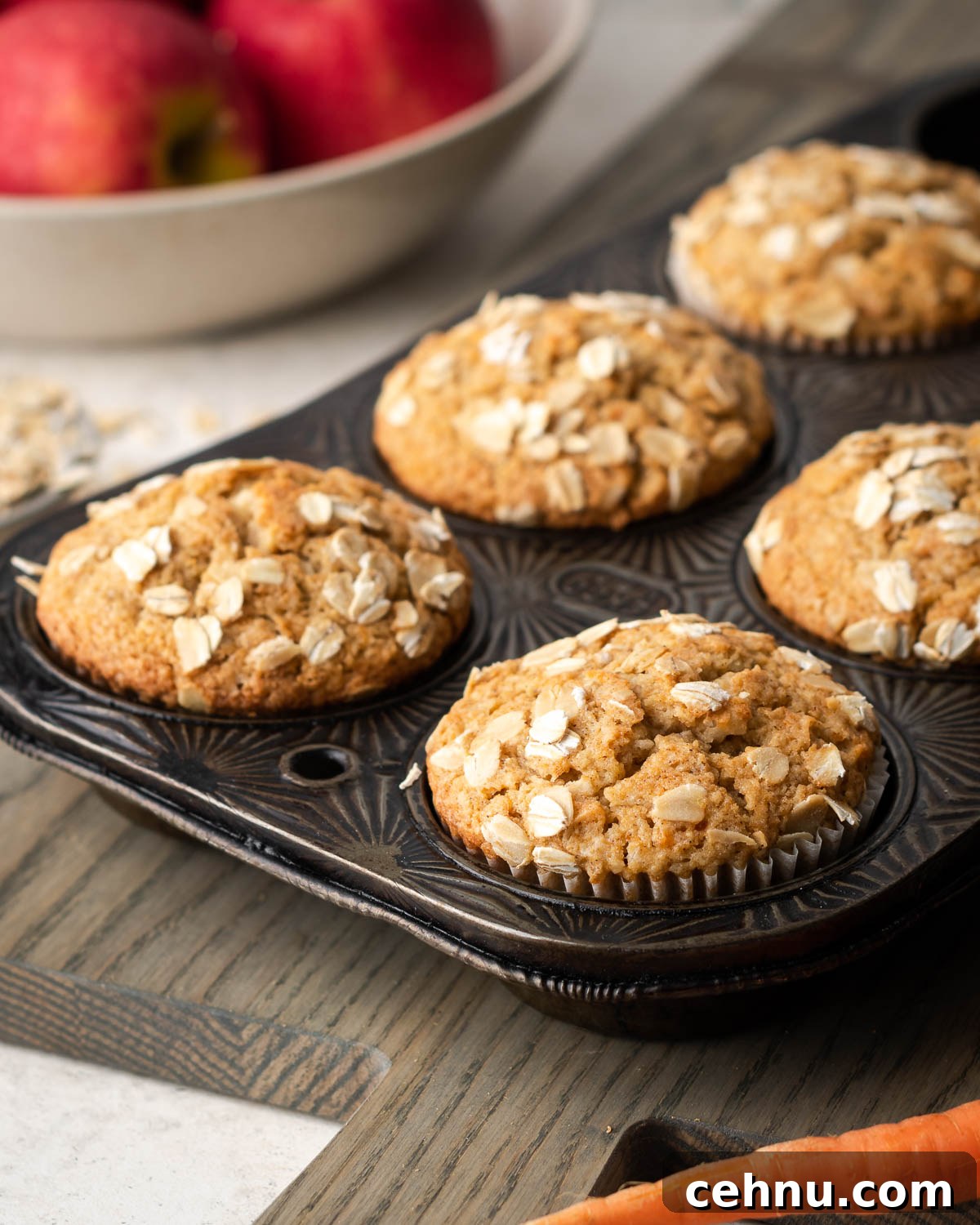 easy apple carrot muffins Freshly baked applesauce carrot muffins in a metal baking tin.