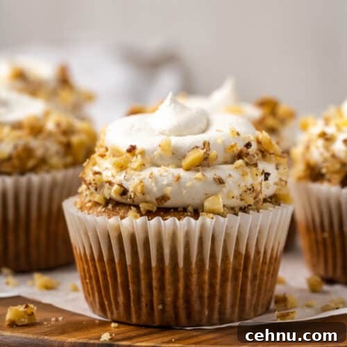 Closeup of a gluten free carrot cake cupcake topped with cream cheese frosting.