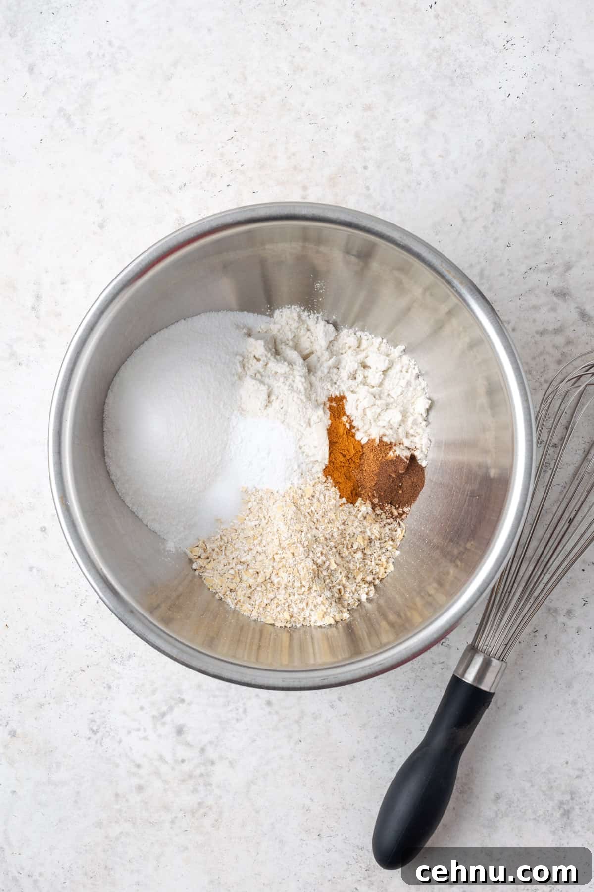 Moist Applesauce Carrot Muffin Recipe with Cinnamon 4 Gluten free flour, oat flour, sugar, baking powder, salt and spices combined together in a metal mixing bowl.