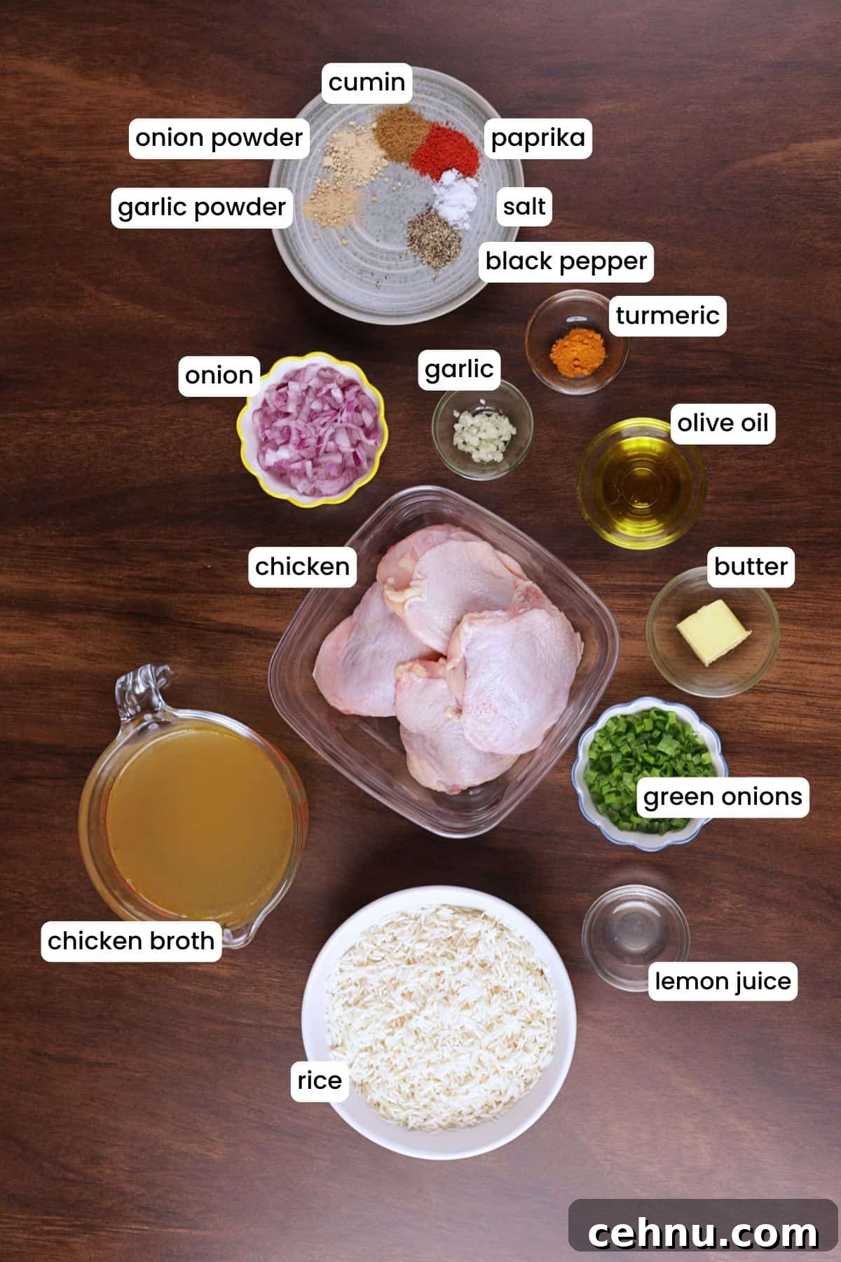 Chicken thighs, rice, onion, garlic, turmeric, chicken broth, and spices for chicken and yellow rice.