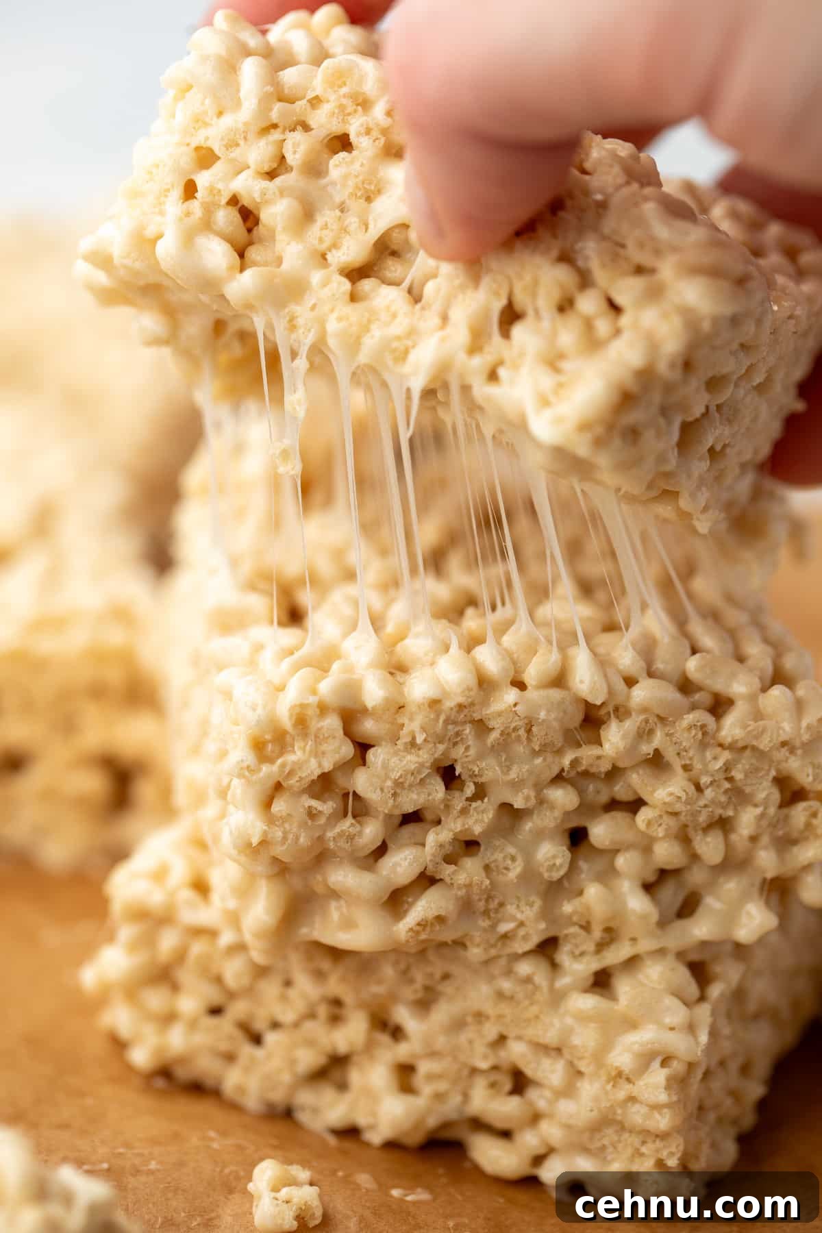 Gluten-Free Rice Krispie Treats Recipe 8 Pulling a cereal treat from on top of a stack.