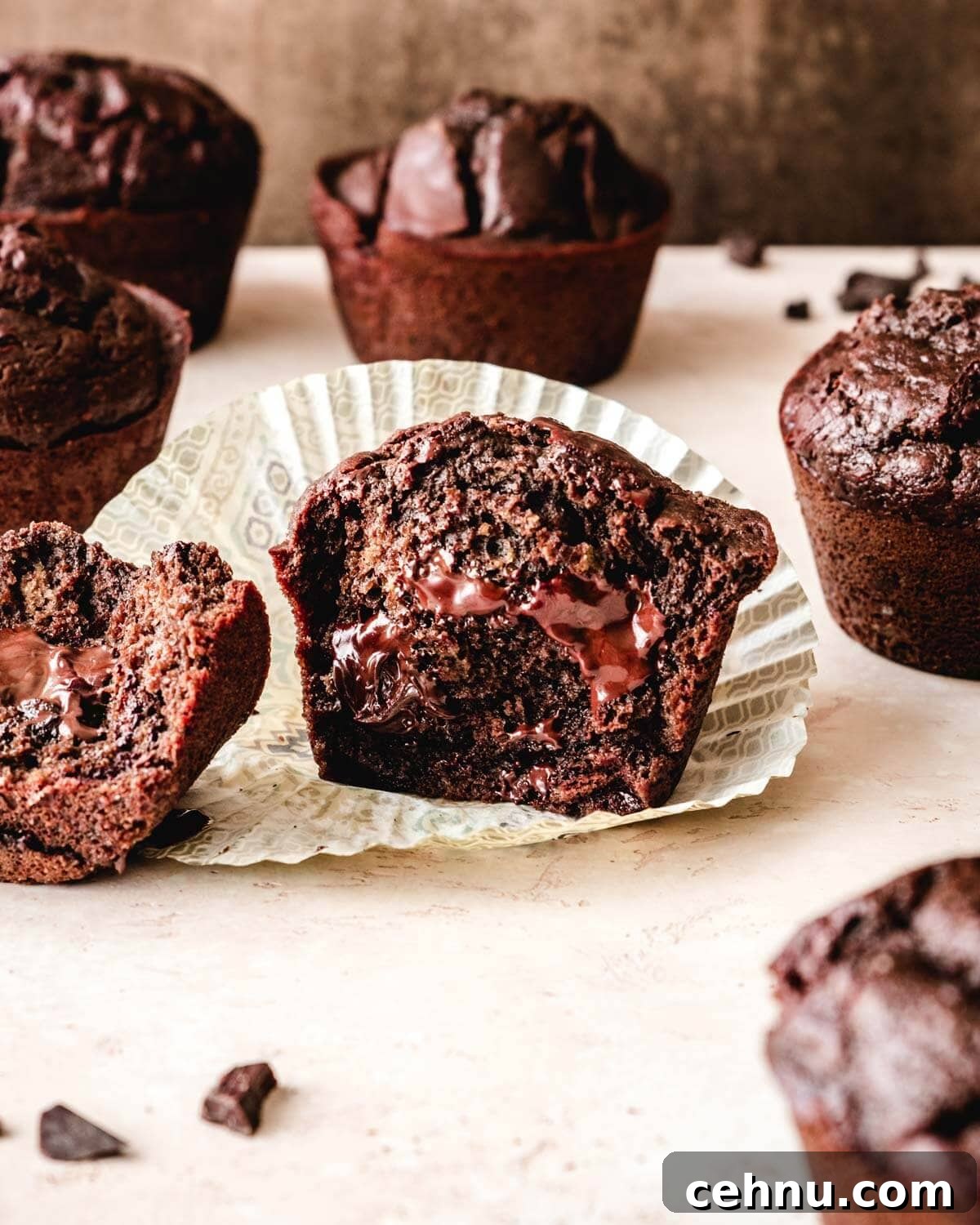 Jumbo chocolate muffin cut in half with melty chocolate chips.