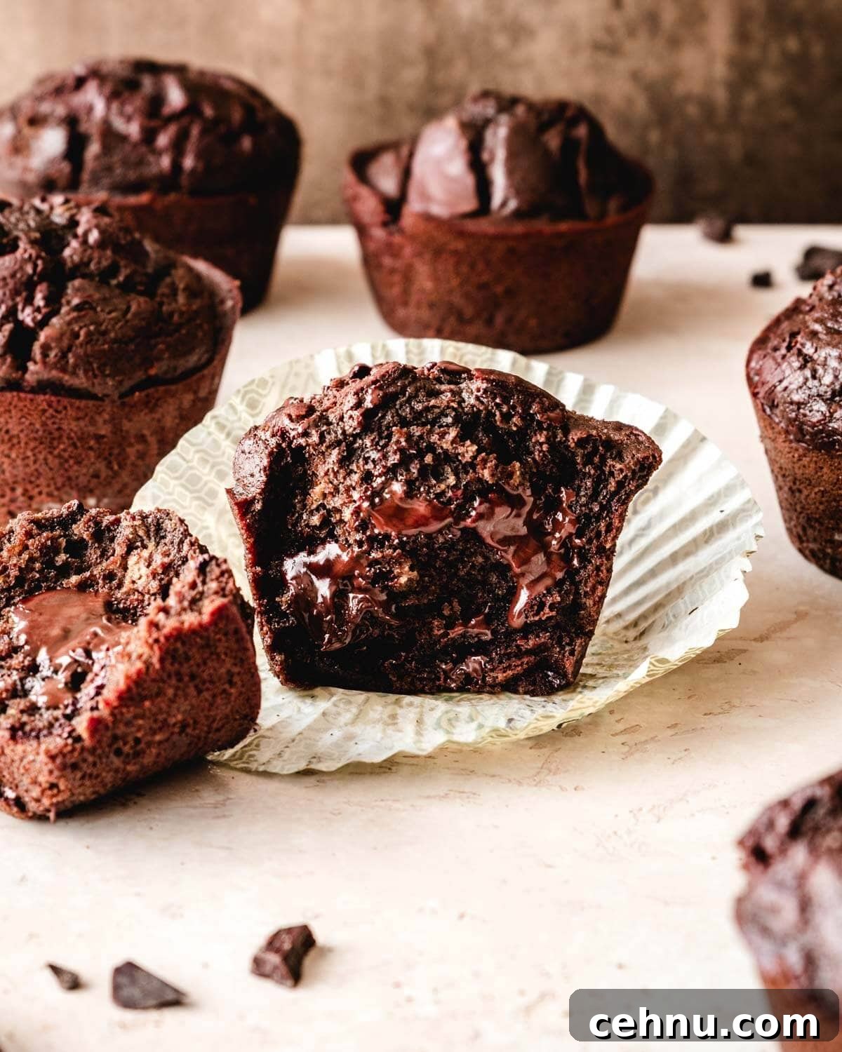 Bakery style chocolate chunk muffin split in half.