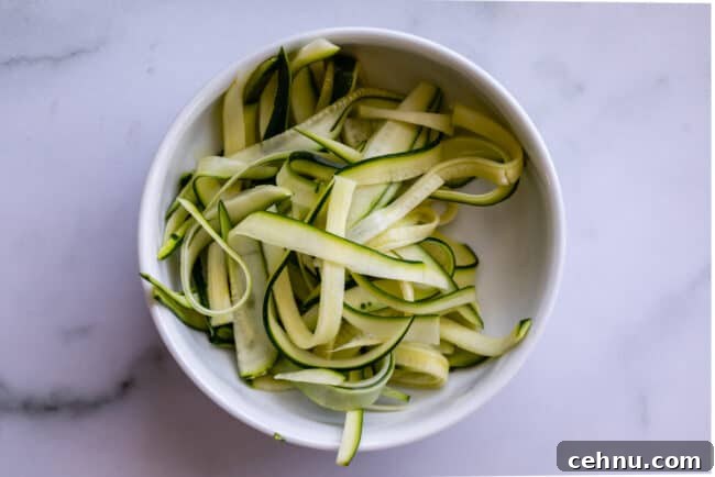 Zucchini ribbons in a white bowl.