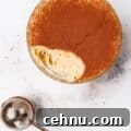 Keto Tiramisu Cottage Cheese Cookie Dough with one bite taken out with cocoa powder duster