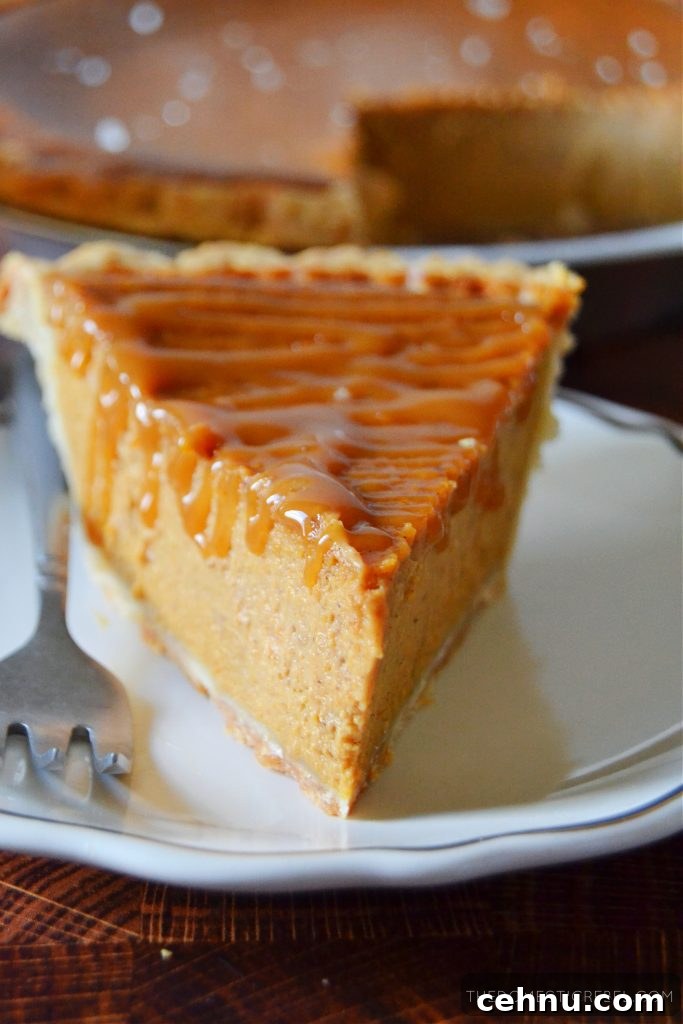 Salted Caramel Pumpkin Pie Recipe for Thanksgiving 3 a closeup shot of a slice of salted caramel pumpkin pie on a white plate