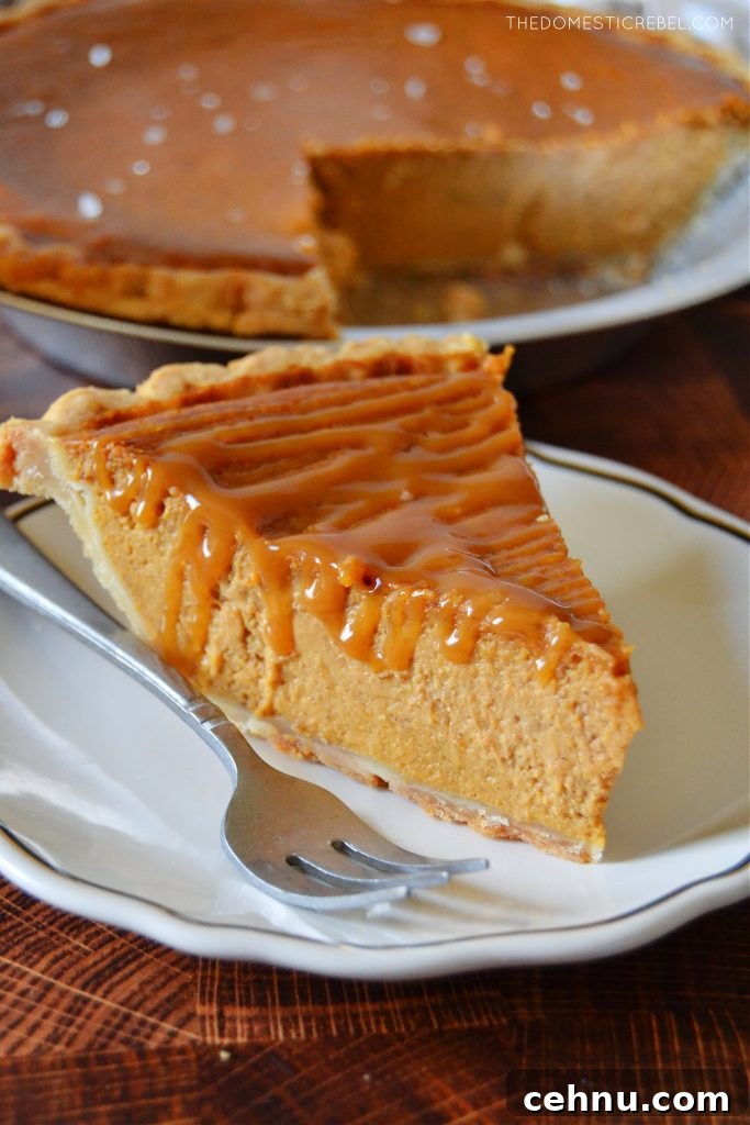 Salted Caramel Pumpkin Pie Recipe for Thanksgiving 5 slice of salted caramel pumpkin pie on a white plate with a fork