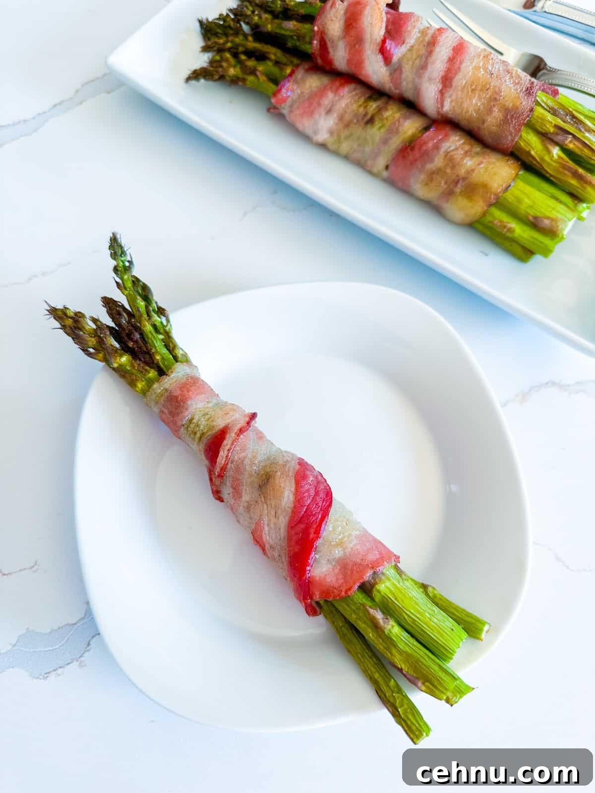 A single servings of bacon and asparagus on a plaate.