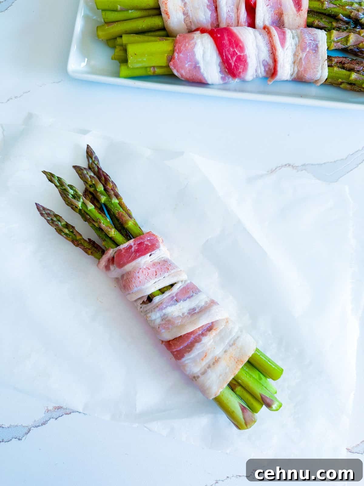 A bundle of asparagus spears wrapped in bacon.