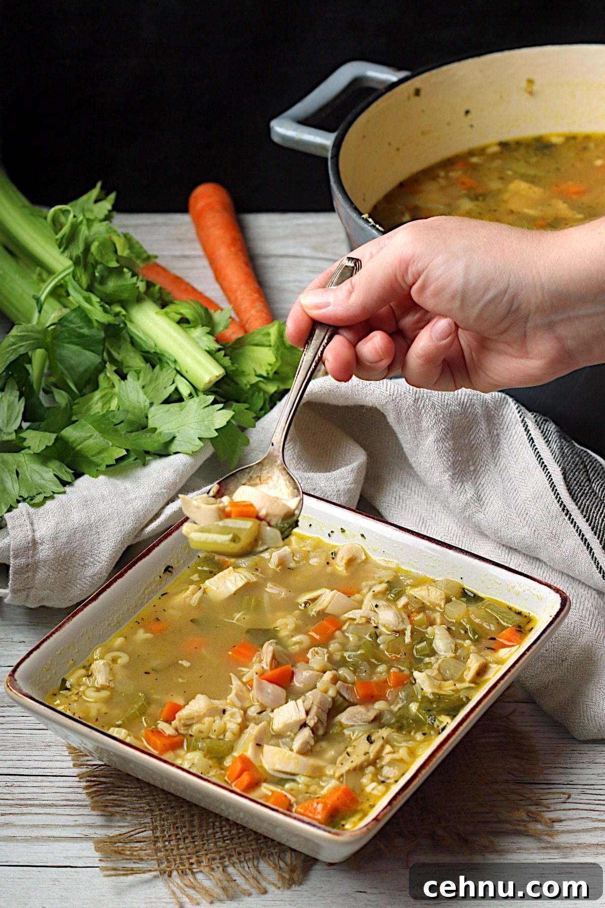 Homemade Leftover Rotisserie Chicken Noodle Soup in a square white bowl