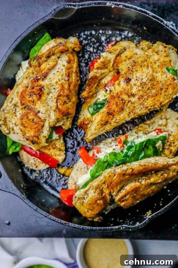 Cheesy Florentine Stuffed Chicken Recipe 6 chicken with spinach, cheese, and bell pepper stuffed in the center in a skillet.