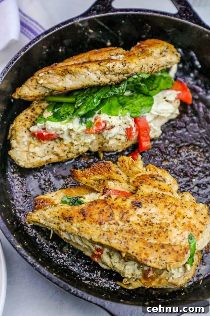 Cheesy Florentine Stuffed Chicken Recipe 3 chicken with spinach, cheese, and bell pepper stuffed in the center in a cast iron skillet.
