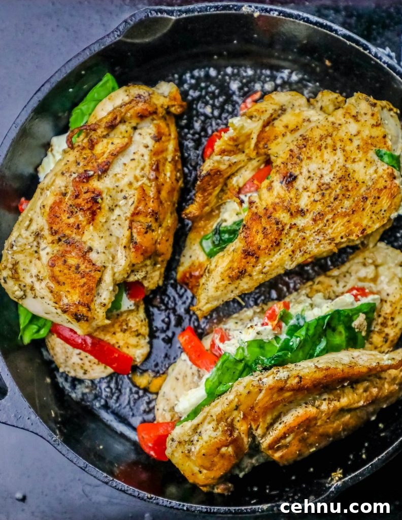 Cheesy Florentine Stuffed Chicken Recipe 5 chicken with spinach, cheese, and bell pepper stuffed in the center in a skillet.