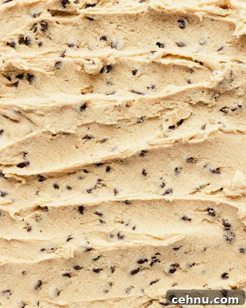 edible cookie dough spread on a sheet with chocolate chips