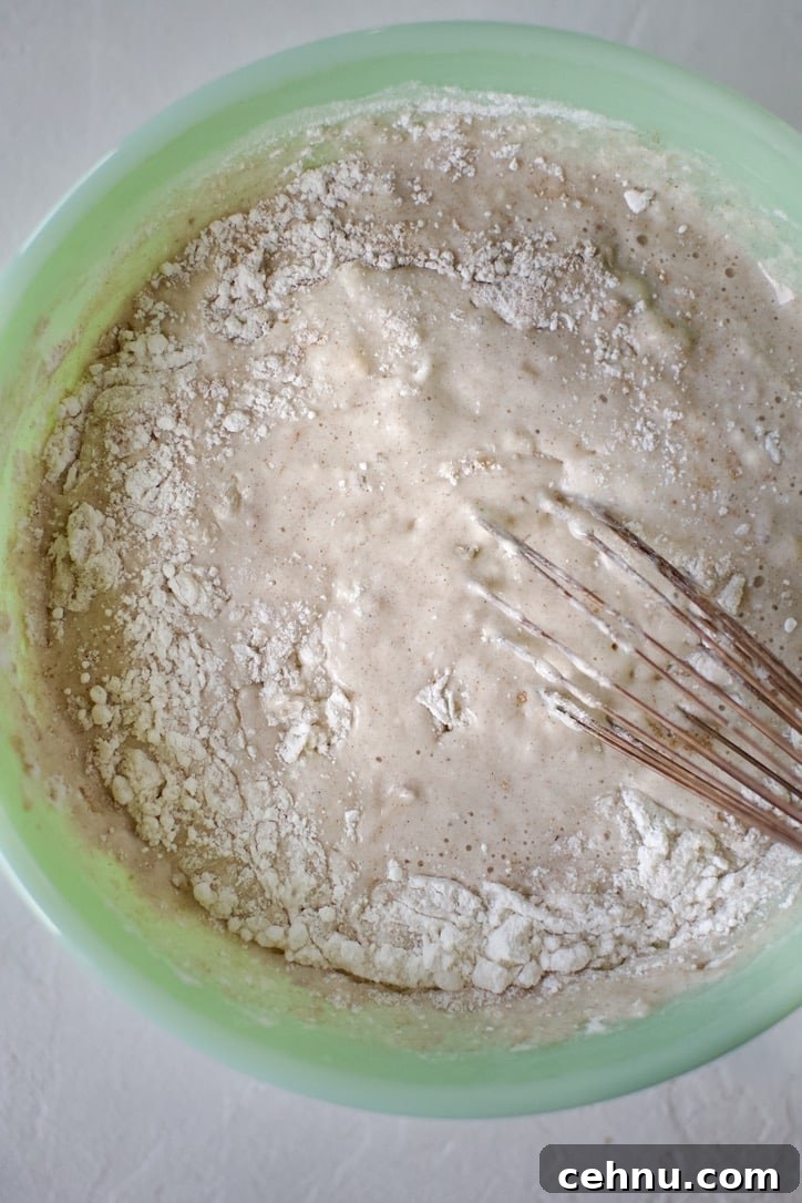 Whisking in the wet ingredients into the pancakes mix.