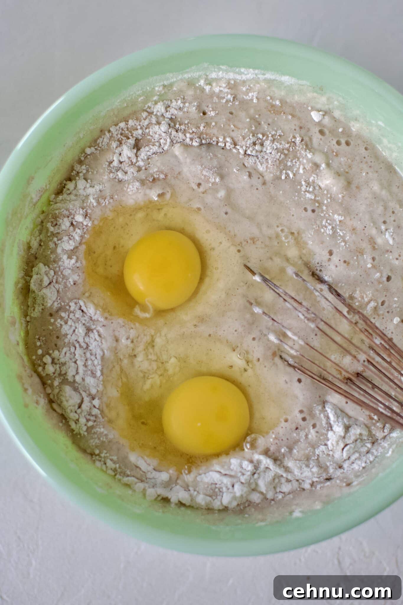 Whisking the eggs the pancakes mix.
