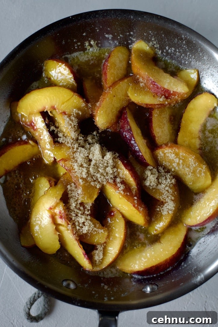 Adding the brown sugar into the sauteed peaches.