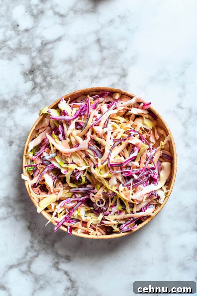 The sauce is combined with the coleslaw mix.