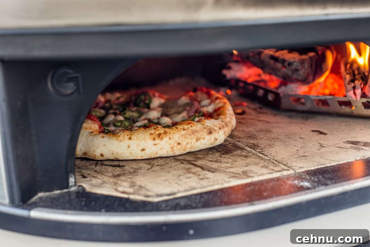 Jalapeño pizza cooking in a Gozney Dome pizza oven