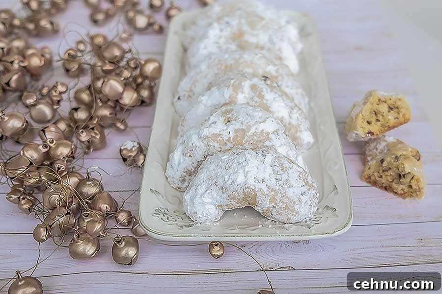 20 Gluten-Free Cookie Recipes for Holiday Parties and Gifts 3 grain-free crescent cookies dusted with powdered sugar on a white tray