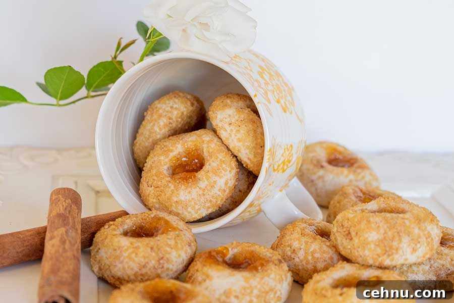 20 Gluten-Free Cookie Recipes for Holiday Parties and Gifts 6 chai thumbprint cookies scattered from a mug onto a table with cinnamon sticks