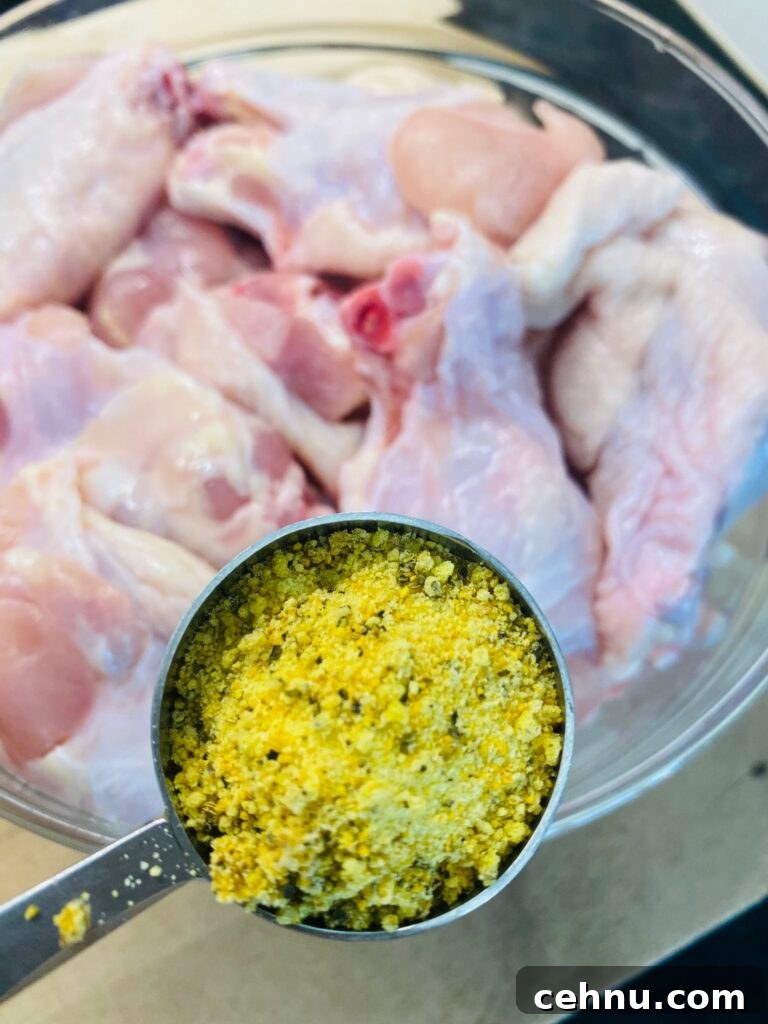 Griddle-Crisped Lemon Pepper Chicken Wings 3 adding lemon pepper seasoning to the wings