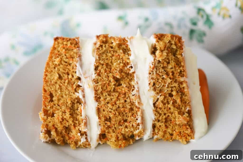 A slice of our classic Carrot Cake recipe on a white plate.