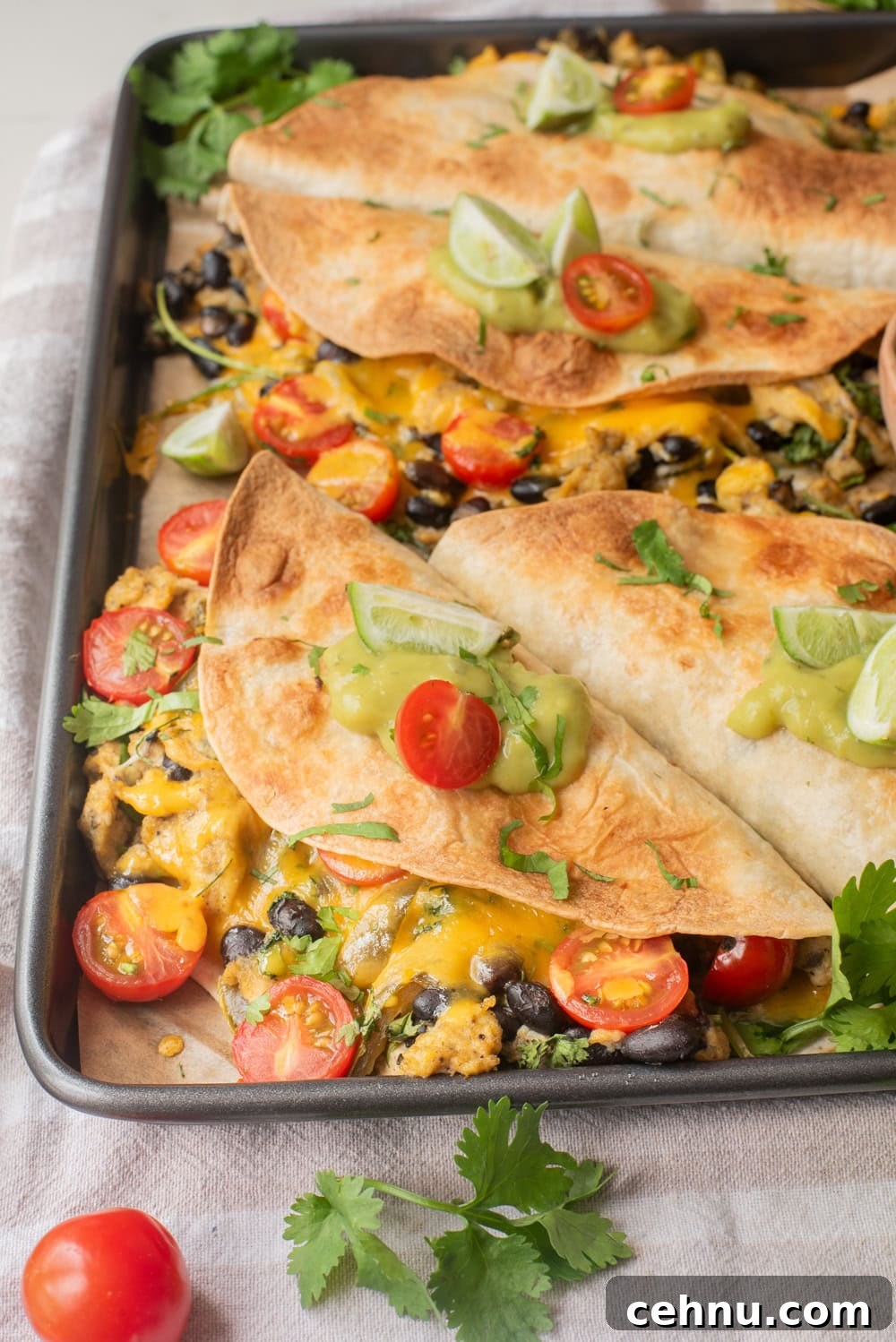 A close up image of vegetarian breakfast quesadillas on a sheetpan.
