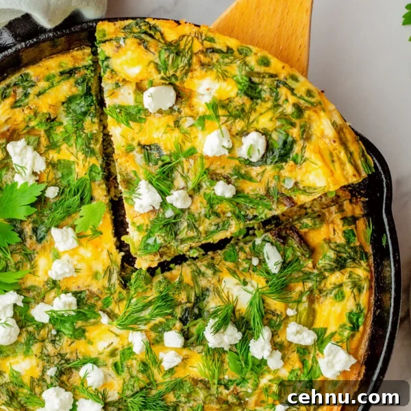 An overhead image of taking a slice out of asparagus frittata.