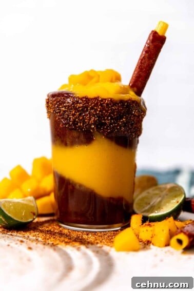 Tajin Seasoning: What It Is and How to Use It 3 Cup of homemade mangonada served with a tamarindo straw.
