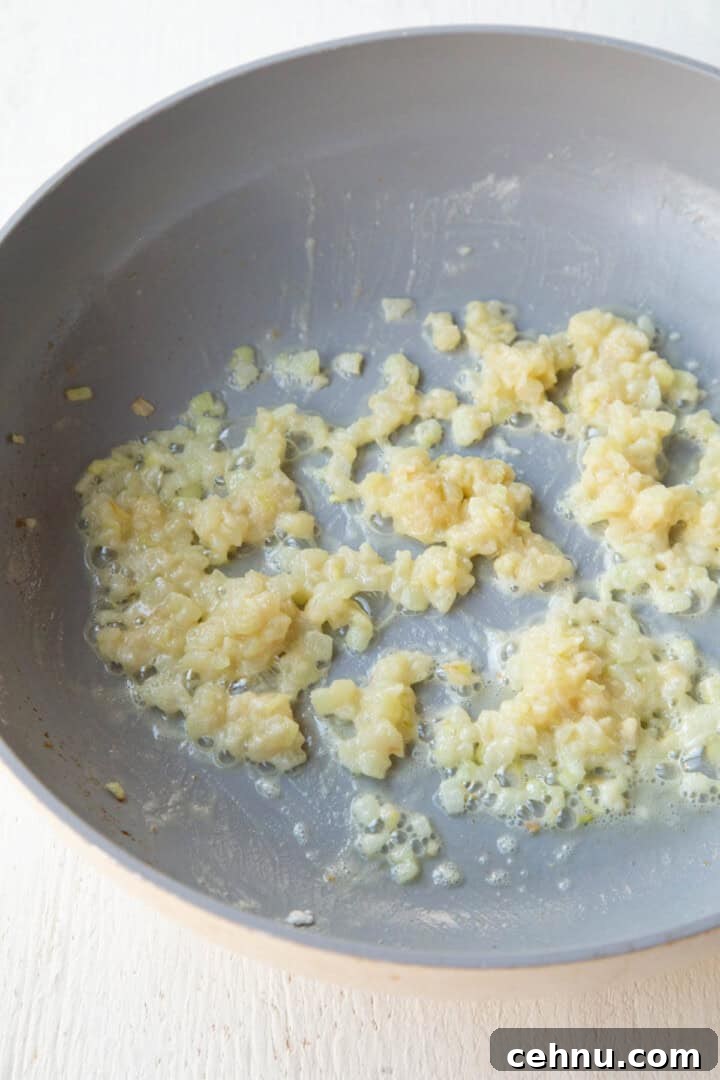 Old Fashioned Scalloped Potatoes Recipe 7 butter and onions cooking in a skillet with flour.