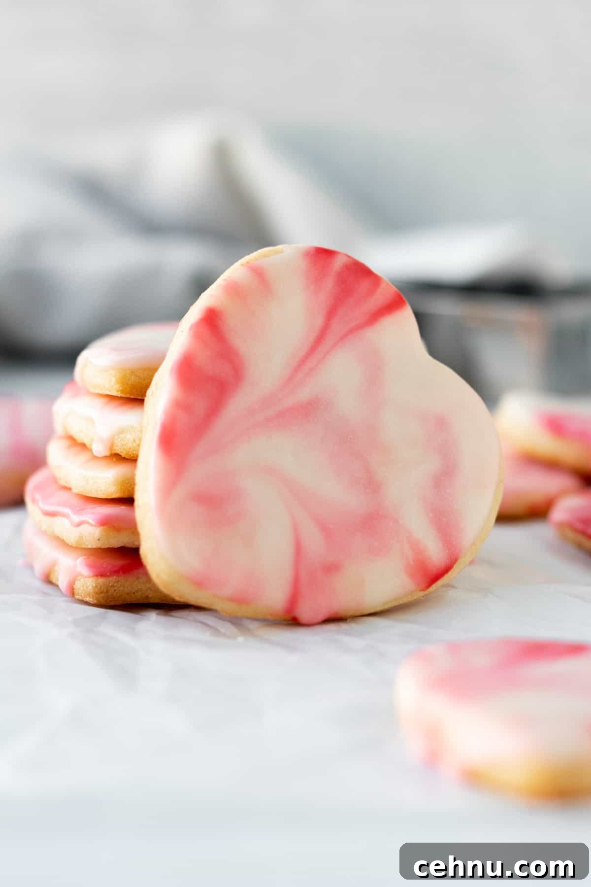 Marbled Sugar Cookie Recipe with Decorating Tips 8 stack of heart shaped marbled sugar cookies with one cookie leaning against the stack