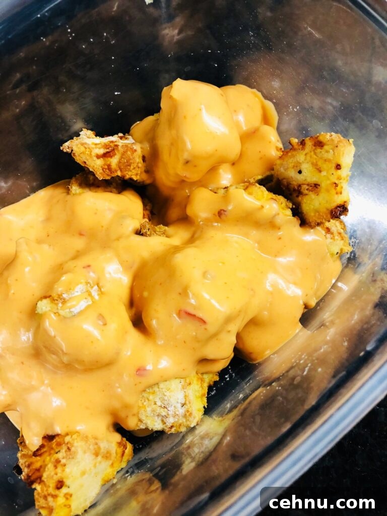 coating the chicken bites with sauce