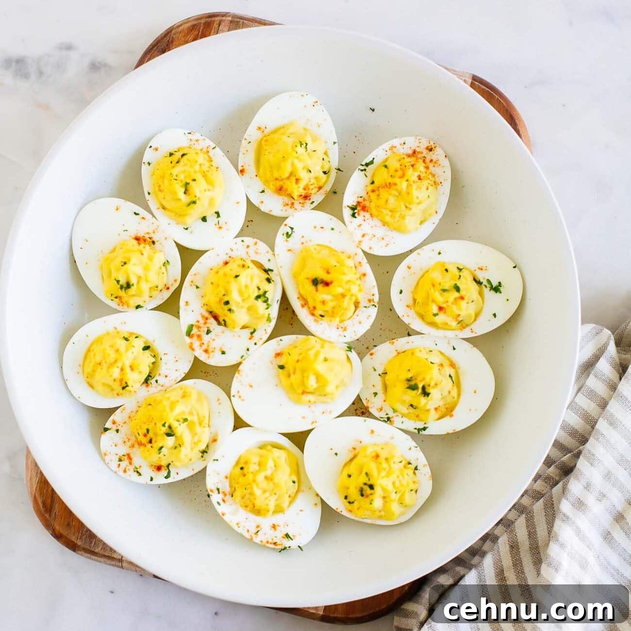 Easter Menu Ideas: Brunch, Dinner and Dessert Recipes 3 Overhead of Deviled eggs on a white plate.