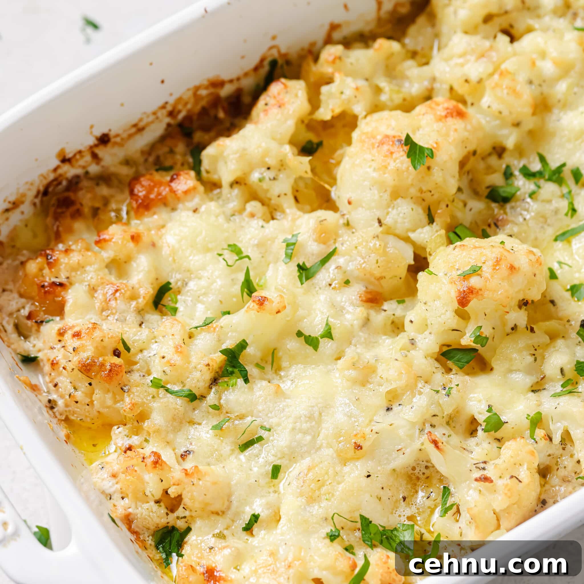 Easter Menu Ideas: Brunch, Dinner and Dessert Recipes 20 Closeup of cauliflower au gratin in a casserole dish.