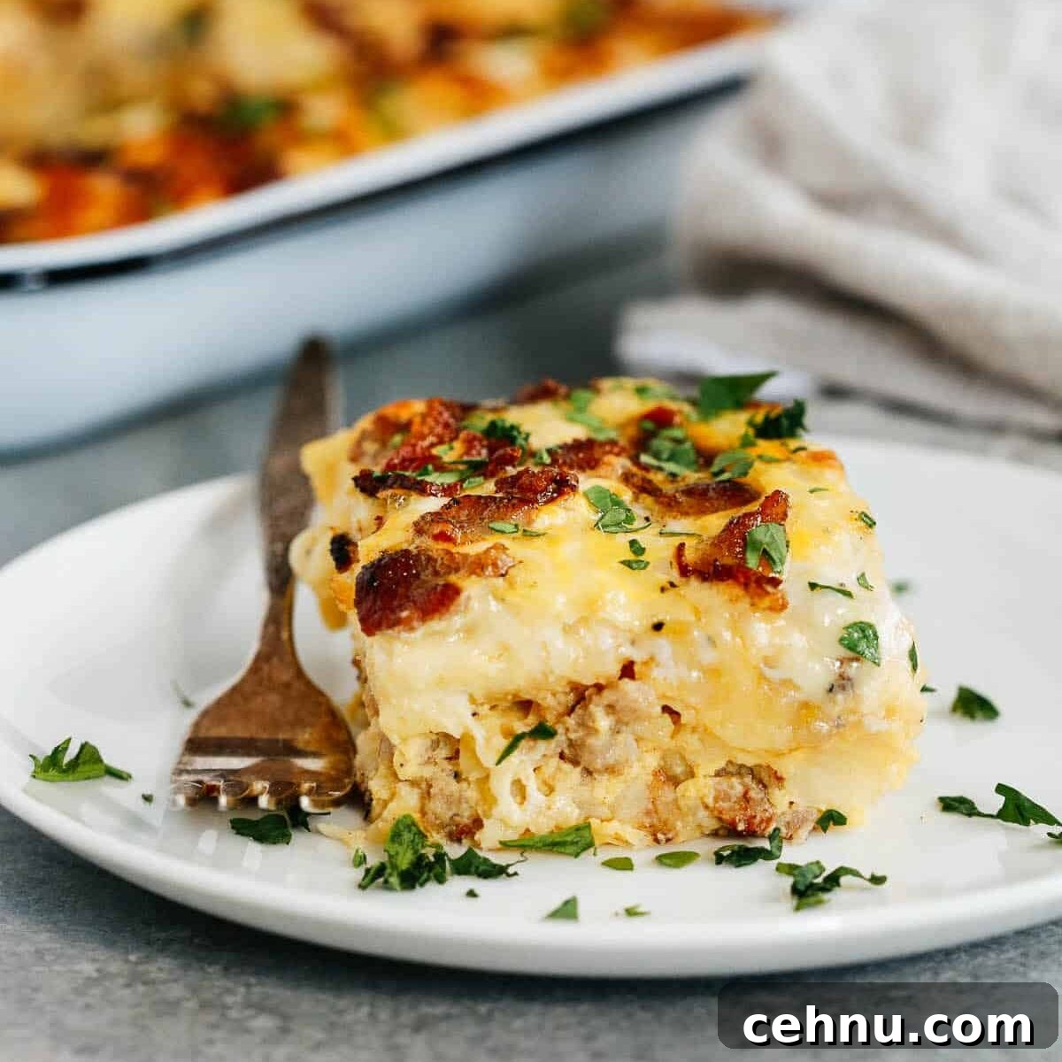 Easter Menu Ideas: Brunch, Dinner and Dessert Recipes 7 A serving of sausage and potato casserole on a white plate.