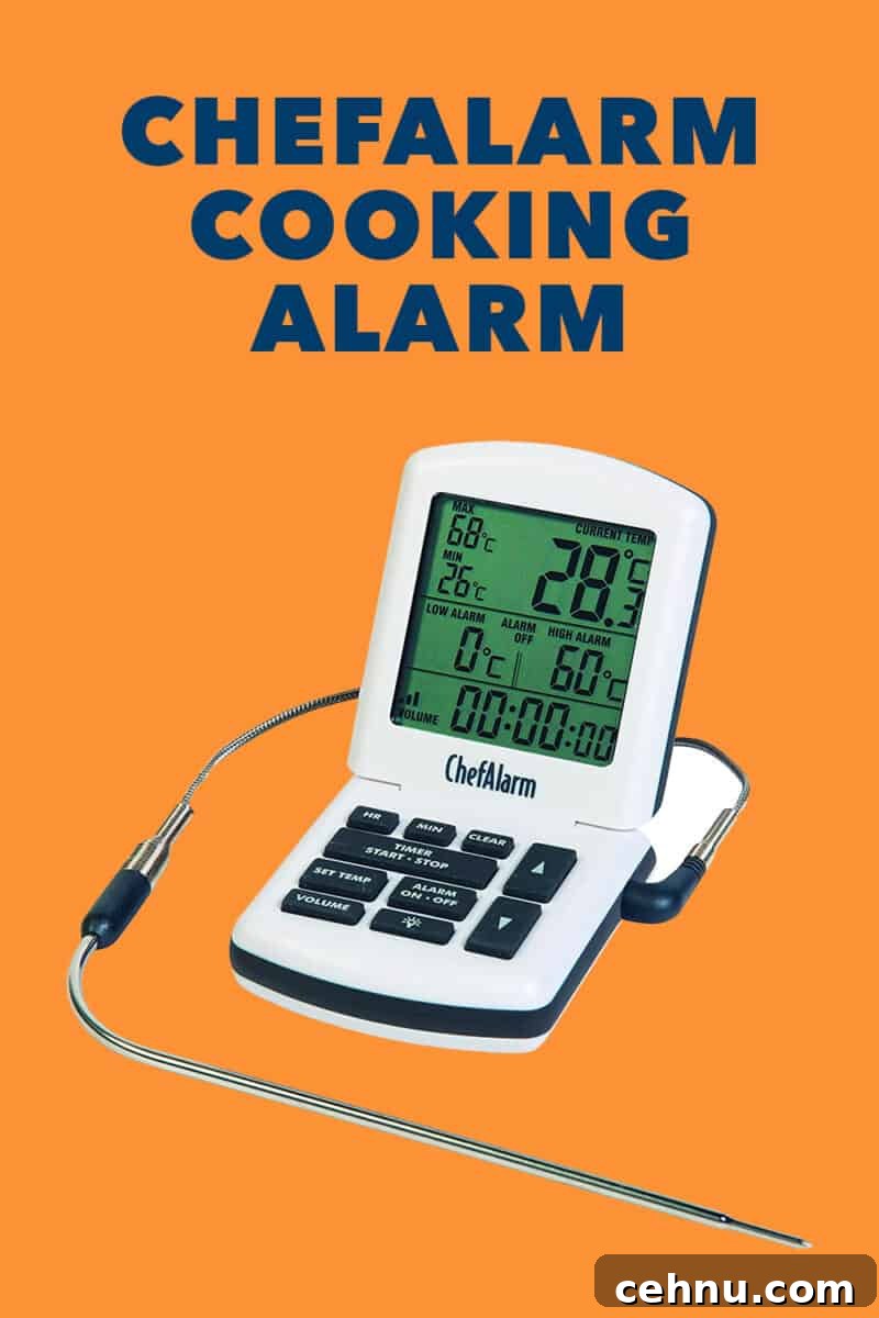 A white ChefAlarm in oven thermometer on an orange background.