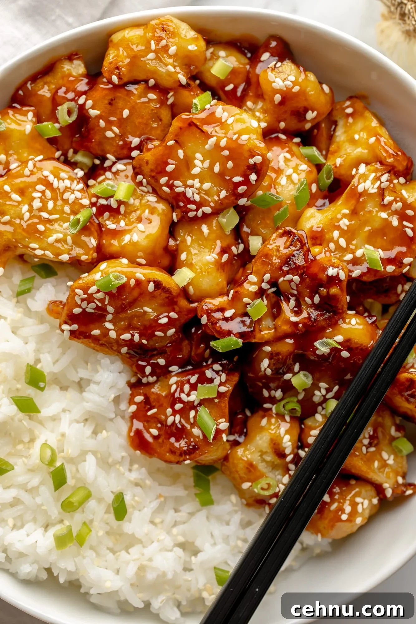 Overhead view of sesame cauliflower in a bowl with rice.