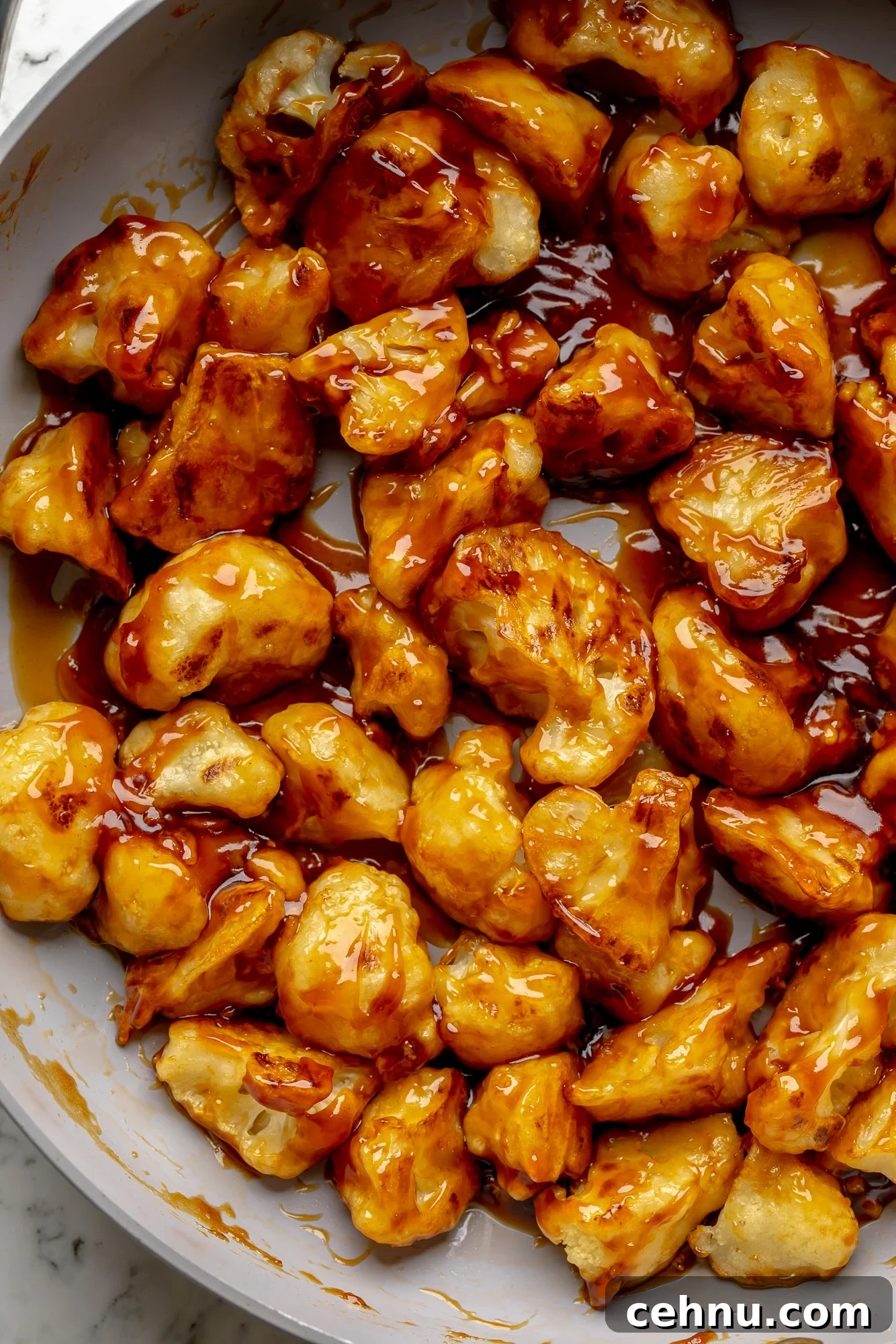 Overhead view of sesame cauliflower in a skillet.