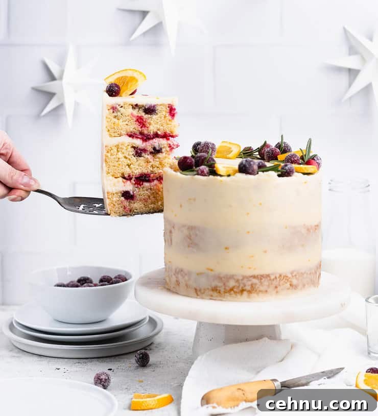 Hand taking a slice of cake out of a larger three layer cake.