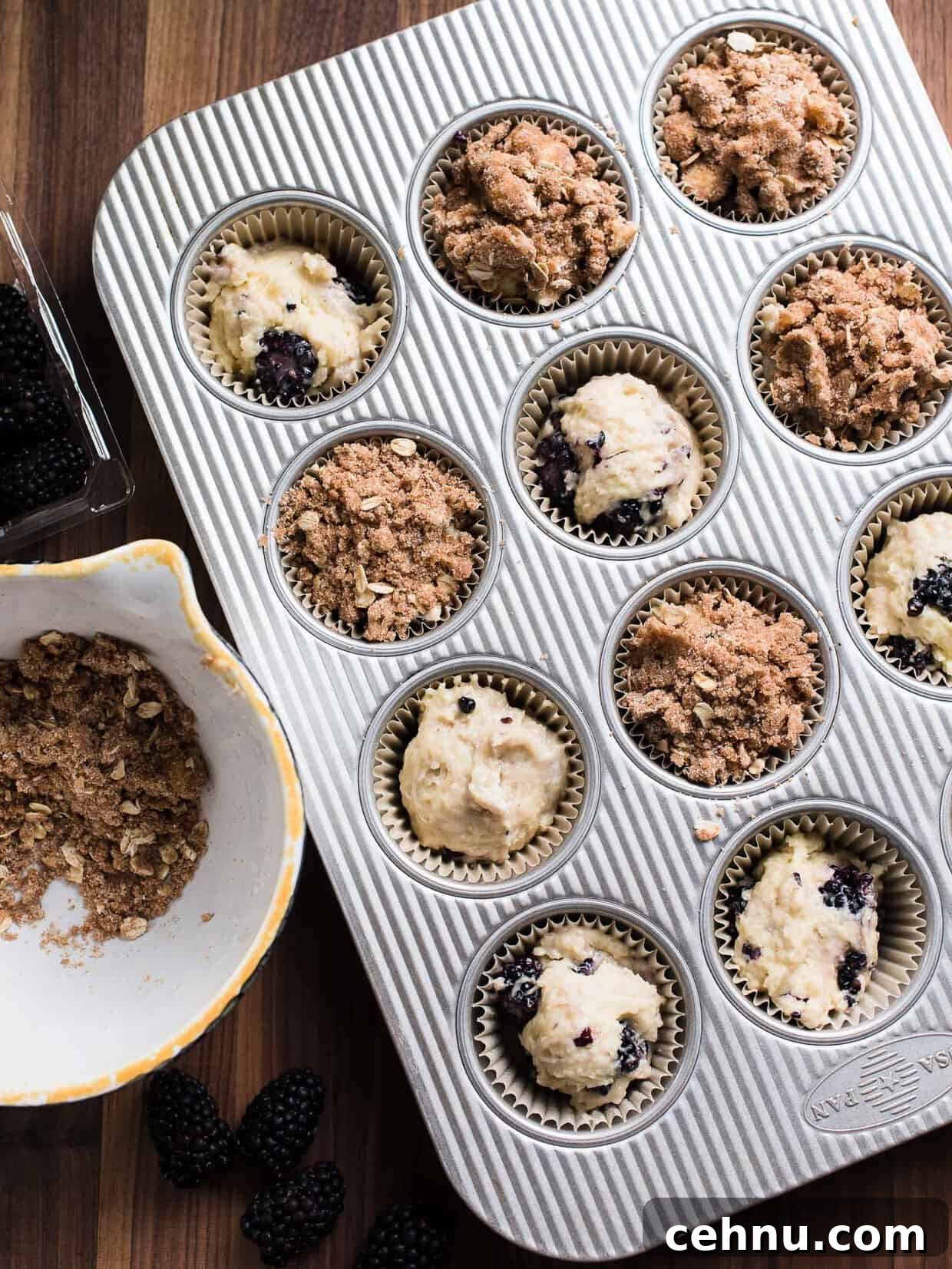 Moist Blackberry Yogurt Muffins with Lemon Zest 3 Blackberry Yogurt Muffins in a muffin tin ready to be baked.